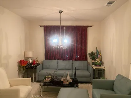 a living room with furniture and flowers