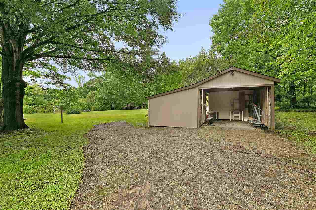 58 John Brown Road Beech Bluff, TN 38313 - Photo 17 of 18 a view of a house with a yard and large tree