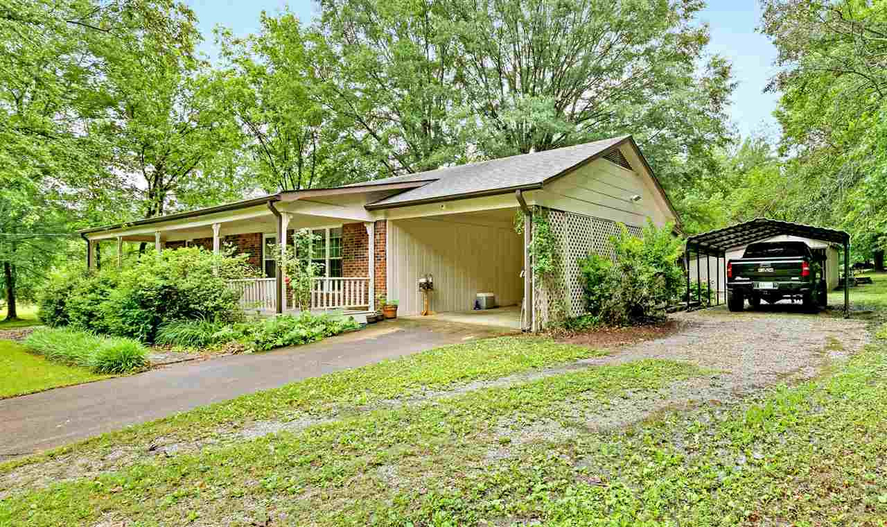 58 John Brown Road Beech Bluff, TN 38313 - Photo 2 of 18 a front view of a house with a yard and potted plants