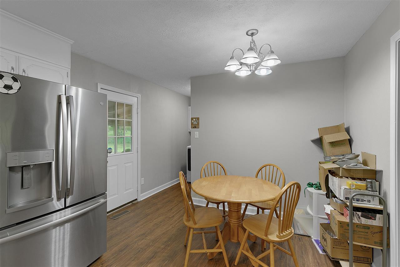 58 John Brown Road Beech Bluff, TN 38313 - Photo 8 of 18 a view of a dining room with furniture a chandelier and wooden floor