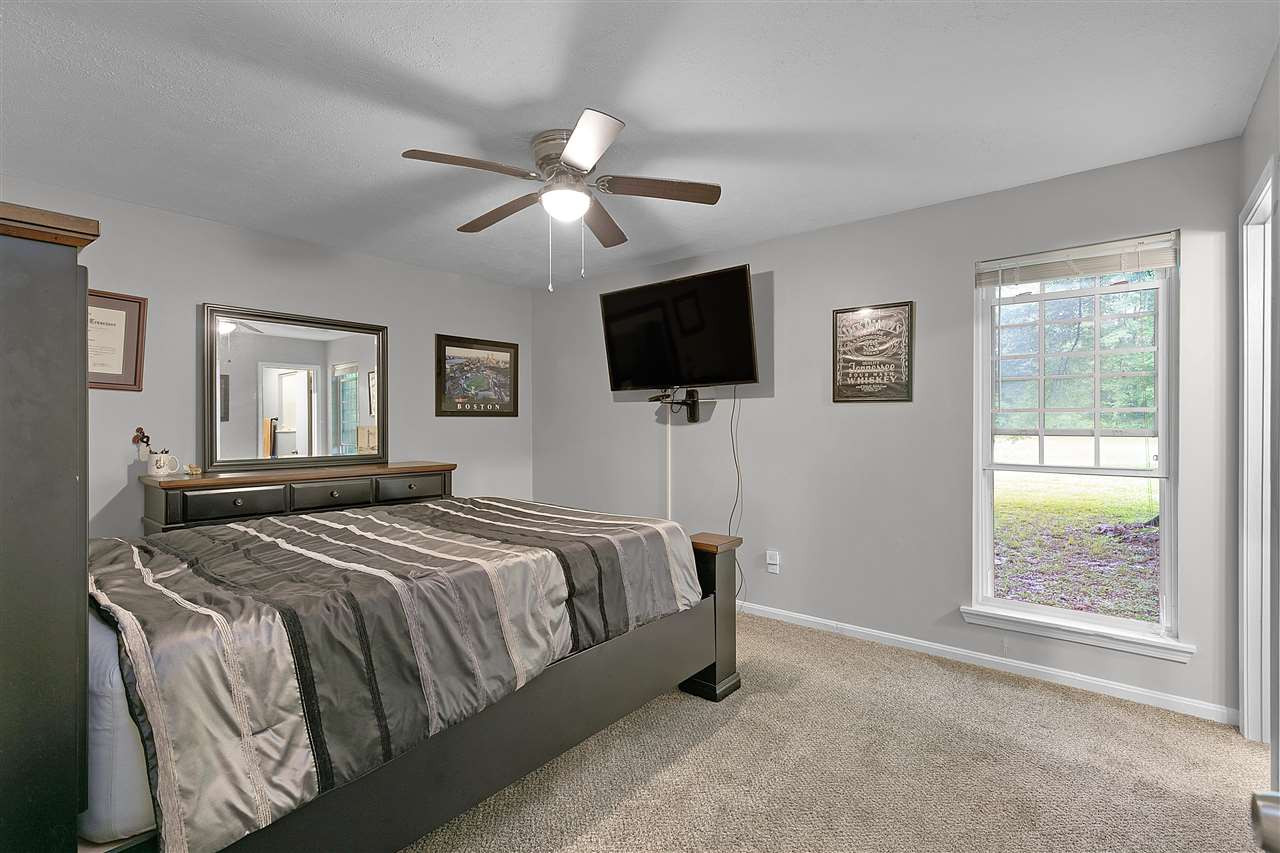 58 John Brown Road Beech Bluff, TN 38313 - Photo 10 of 18 a bedroom with a bed and a flat screen tv