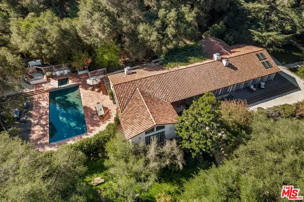 an aerial view of a house with a yard basket ball court and outdoor seating