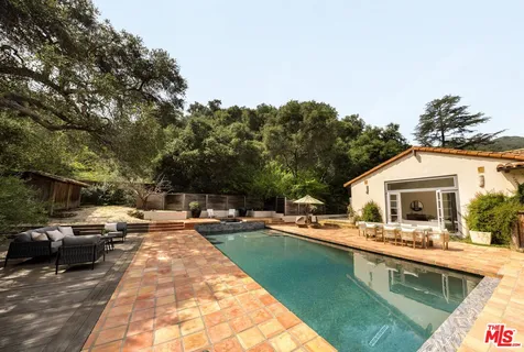 a view of a swimming pool with a lounge chairs