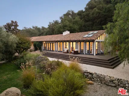 a view of a wooden deck and a yard