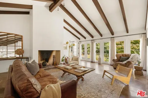 a spacious bedroom with a bed a couch and a window