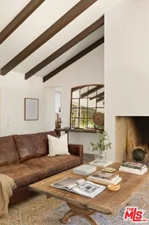 a view of a hallway with wooden floor and a living room