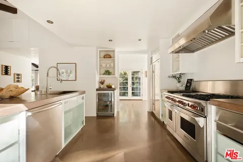 a kitchen with counter top space and living room view