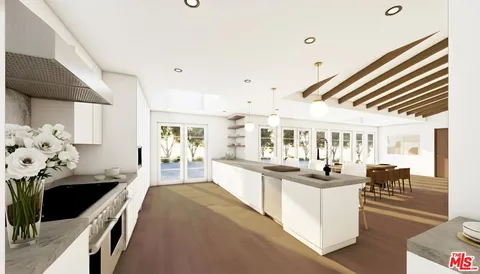 a kitchen with stainless steel appliances kitchen island granite countertop a refrigerator and a stove top oven