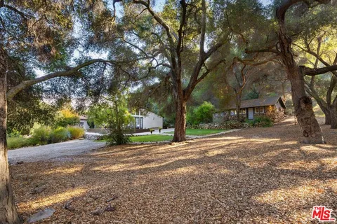 a view of a backyard with sitting area