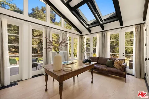 a living room with furniture and large windows
