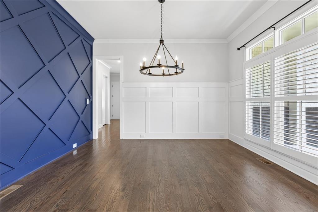 3528 North Bogan Road Buford, GA 30519 - Photo 5 of 79 a view of a room with wooden floor staircase and a ceiling fan