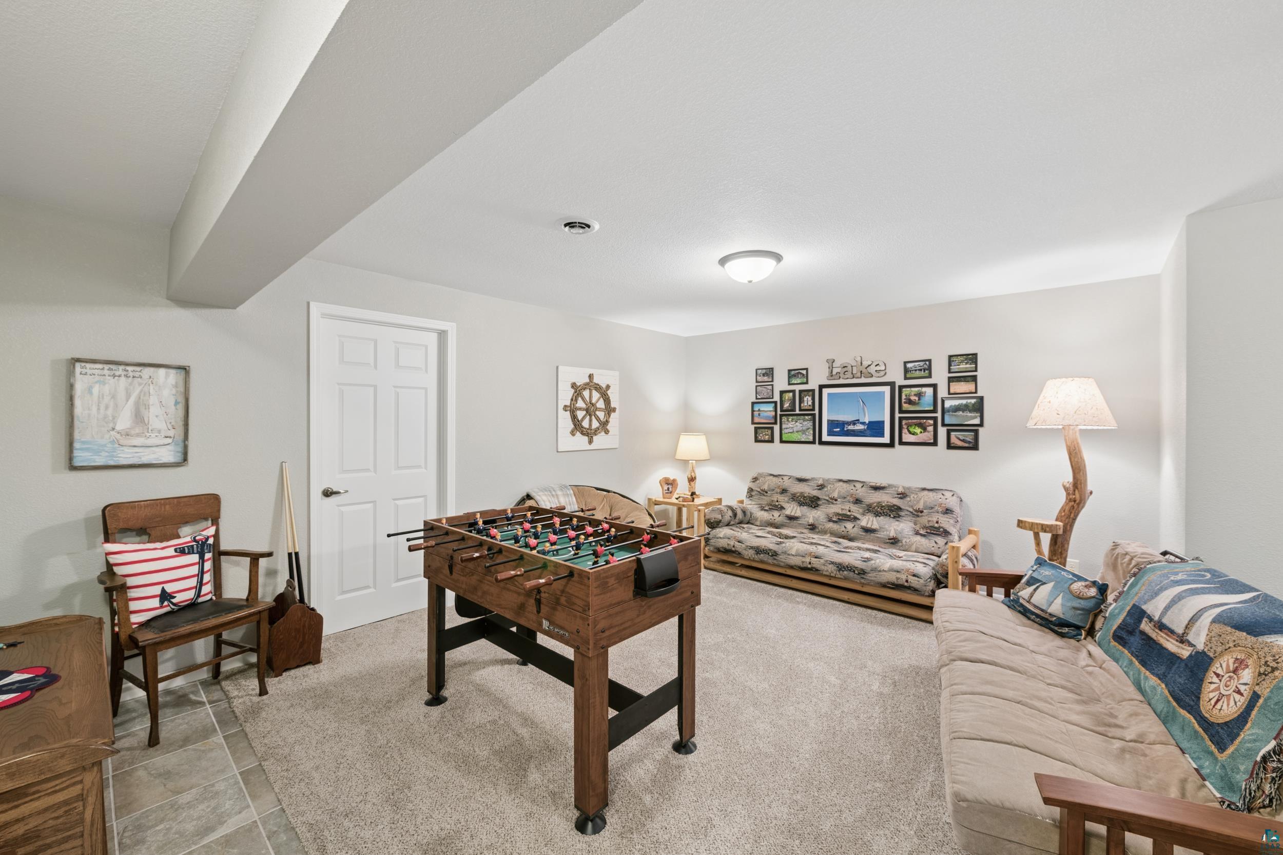 34590 Bay View Road, Unit 801 Bayfield, WI 54814 - Photo 22 of 36 Finished room featuring neutral wall paint, recessed lighting, and a combination of carpet and tile flooring