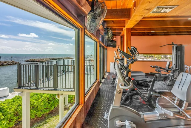 a dining room with furniture and a floor to ceiling window