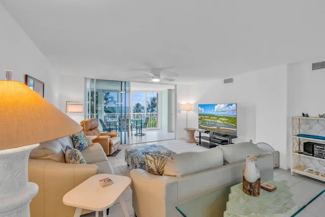 a living room with furniture a table and a flat screen tv
