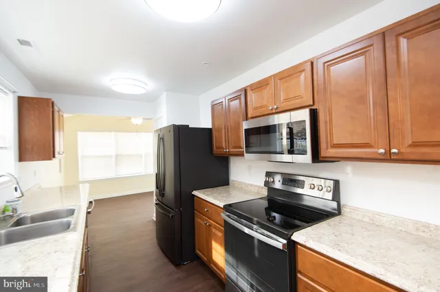 a kitchen with a sink a cabinets and window
