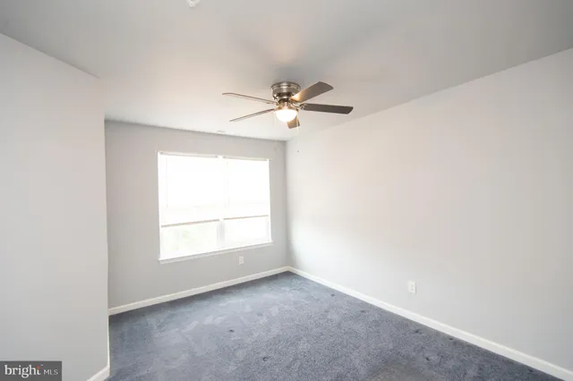 a view of a hallway with wooden floor and entryway
