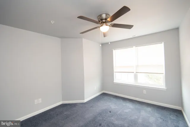a bathroom with a granite countertop sink toilet and mirror