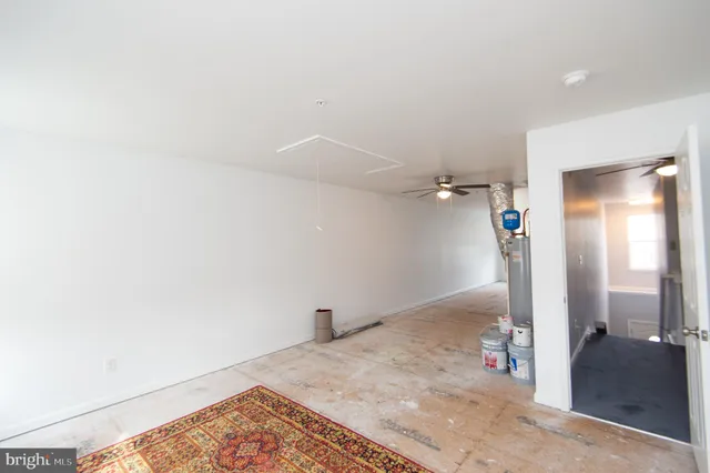 a view of a big yard in front of a brick house with a large tree