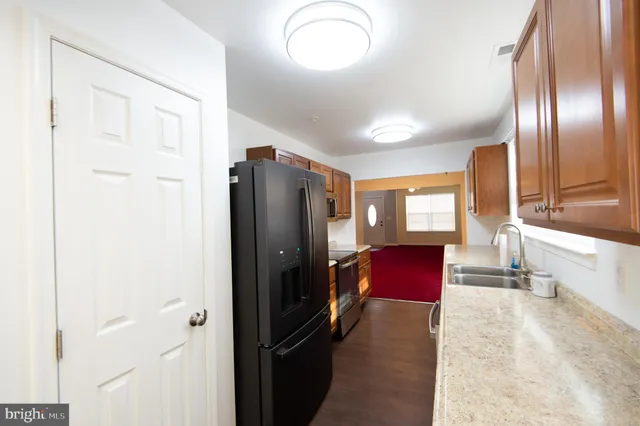 a kitchen with stainless steel appliances granite countertop a refrigerator stove and microwave
