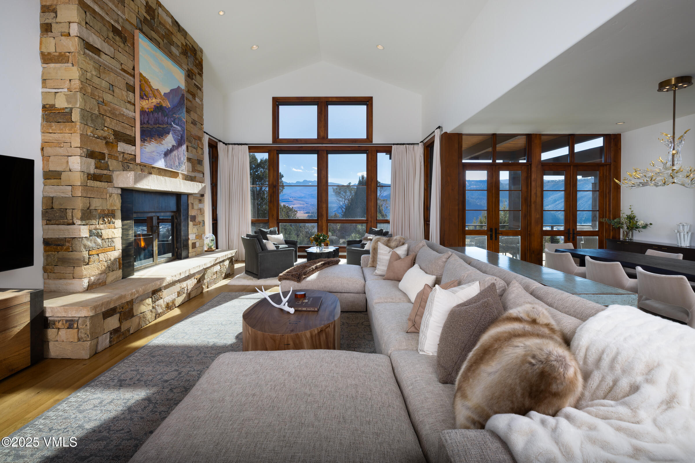 a living room with fireplace furniture and a floor to ceiling window
