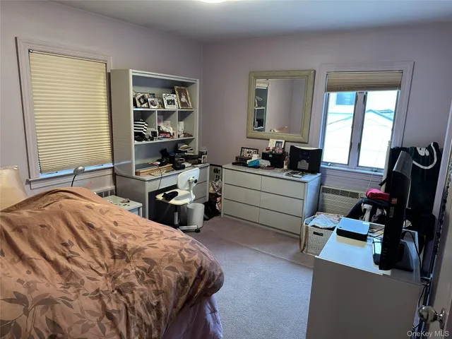 a bedroom with furniture and a flat screen tv