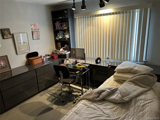 a bedroom with a bed and a baby crib