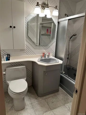 a view of storage and utility room with a window