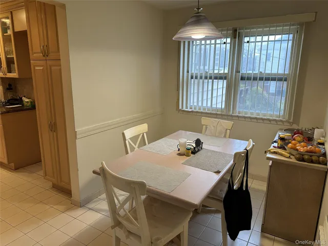 a view of a dining room with furniture and chandelier