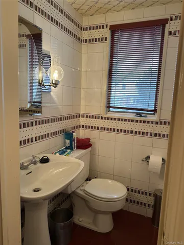 a bathroom with a sink a toilet and mirror