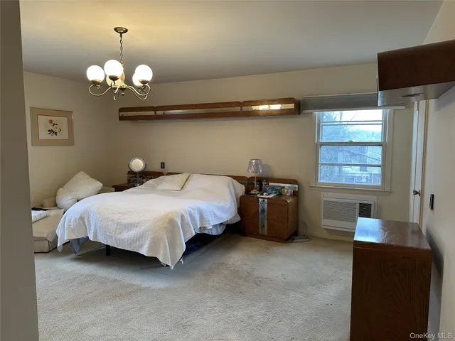 a bed room with a bed and a chandelier