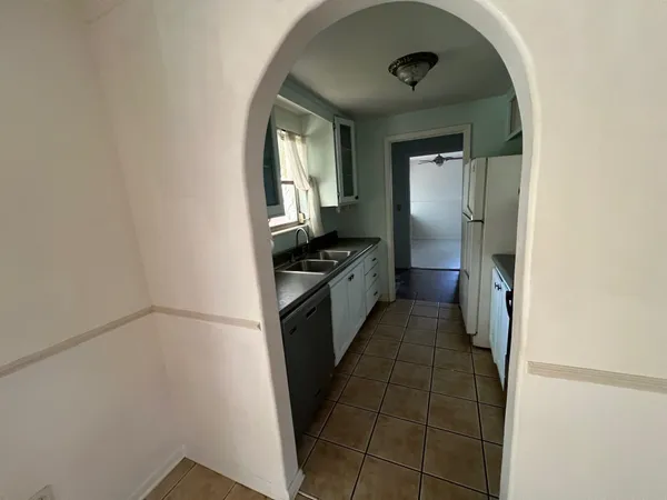 a kitchen with a refrigerator and a stove