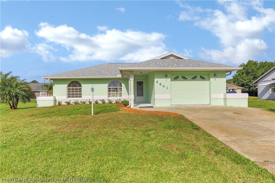 4441 Leaf Road Sebring, FL 33875 - Photo 1 of 21 a view of yellow house with a big yard and potted plants