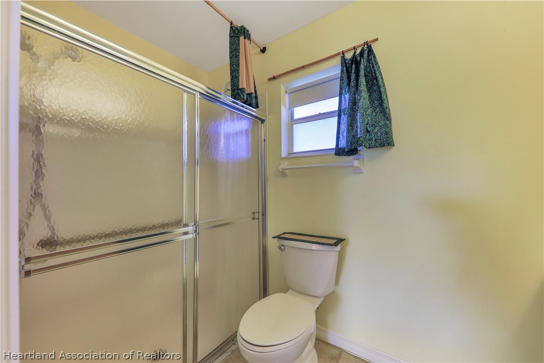 4441 Leaf Road Sebring, FL 33875 - Photo 11 of 21 a white toilet sitting next to a bathroom sink