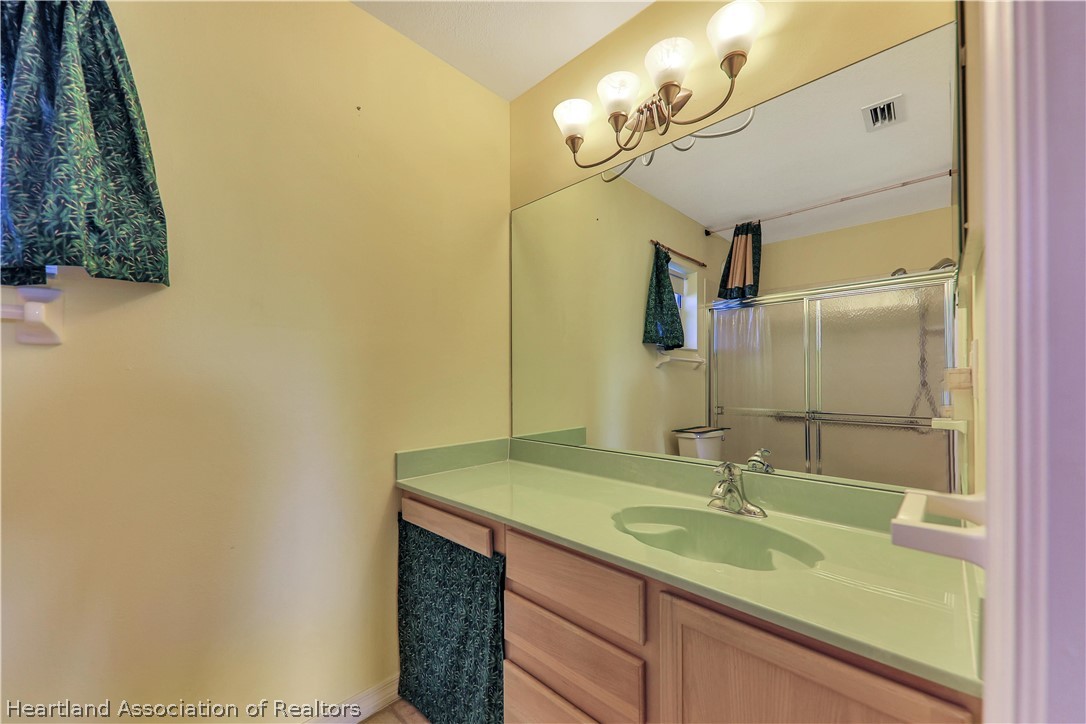 4441 Leaf Road Sebring, FL 33875 - Photo 12 of 21 a bathroom with a granite countertop sink and a mirror