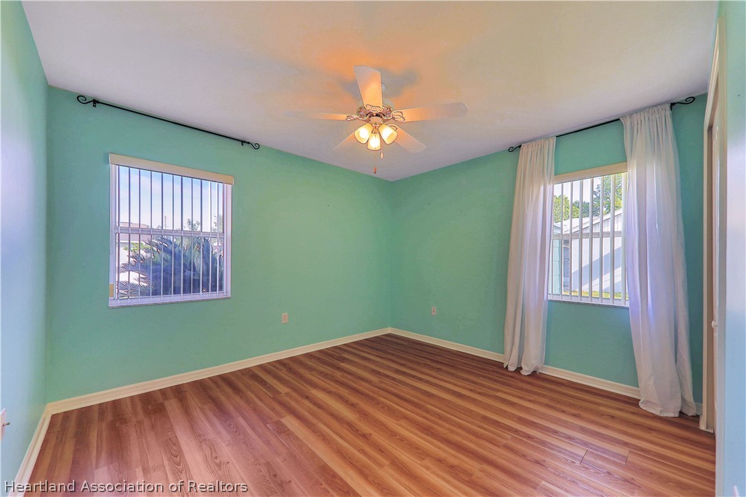 4441 Leaf Road Sebring, FL 33875 - Photo 13 of 21 a view of an empty room with window and wooden floor