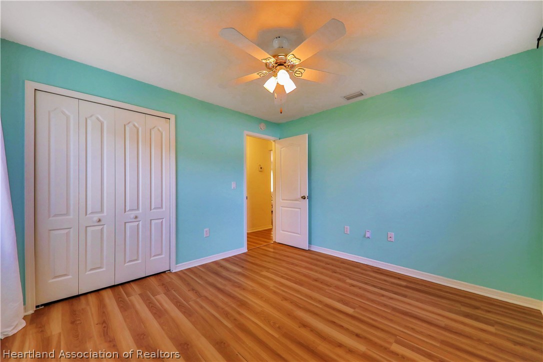 4441 Leaf Road Sebring, FL 33875 - Photo 14 of 21 wooden floor in an empty room with a window