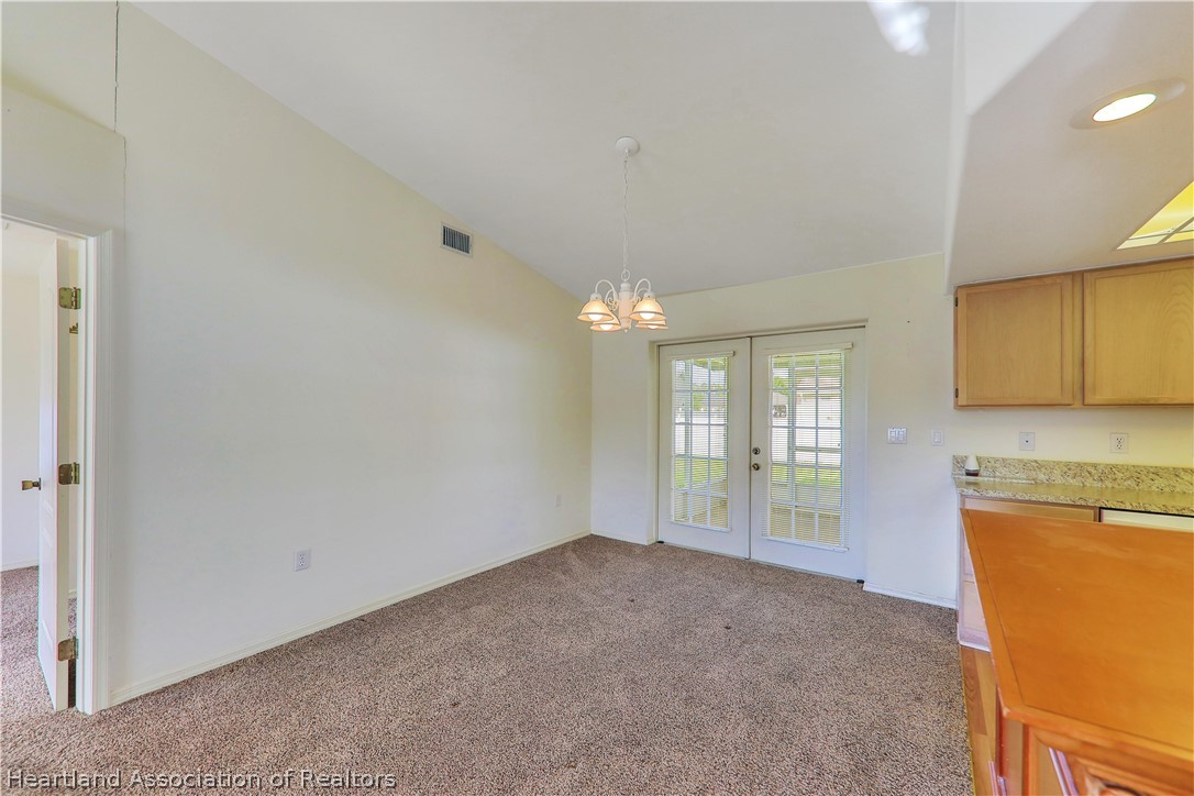 4441 Leaf Road Sebring, FL 33875 - Photo 5 of 21 a view of a kitchen with an empty space and a window