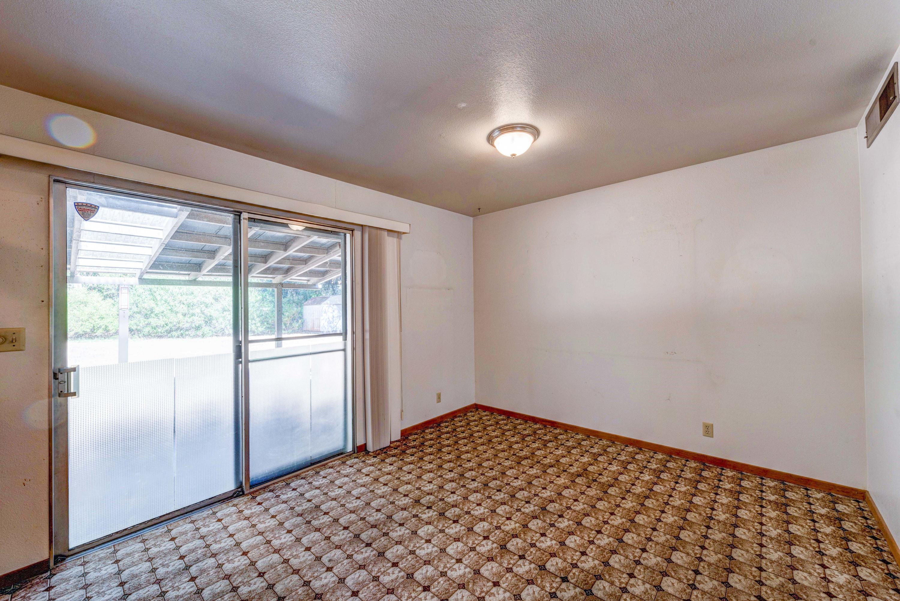 2044 Canyon Road Redding, CA 96001 - Photo 8 of 21 a view of a big room with wooden floor and a window