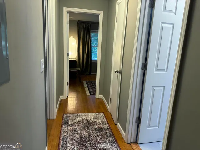 a view of hallway with wooden floor