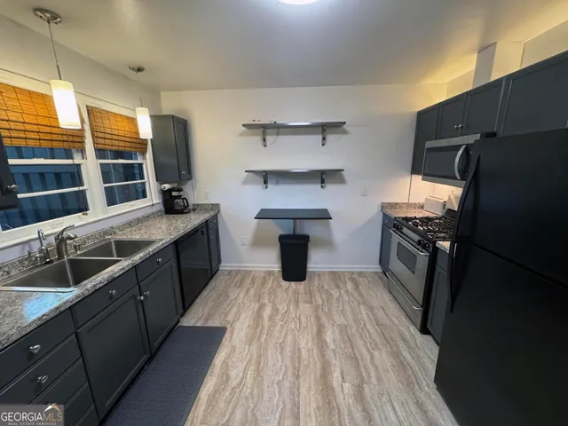 a kitchen with a sink stove and refrigerator