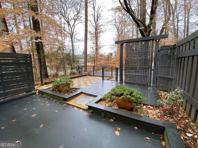 a backyard of a house with lots of green space and outdoor seating