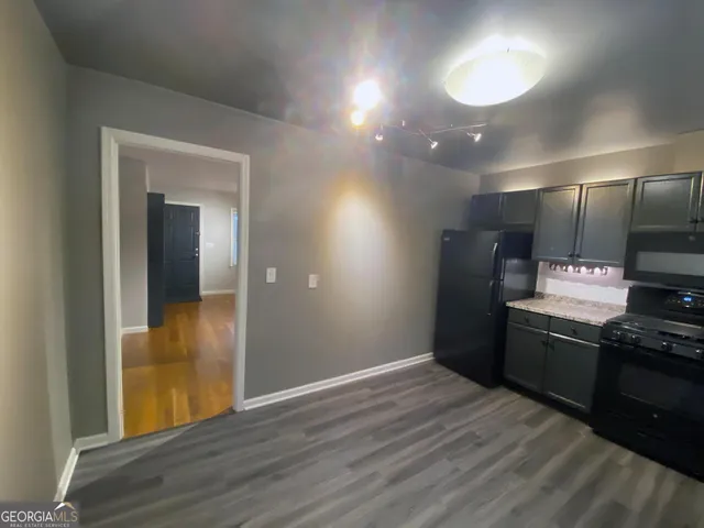 a view of a kitchen with a sink and a refrigerator