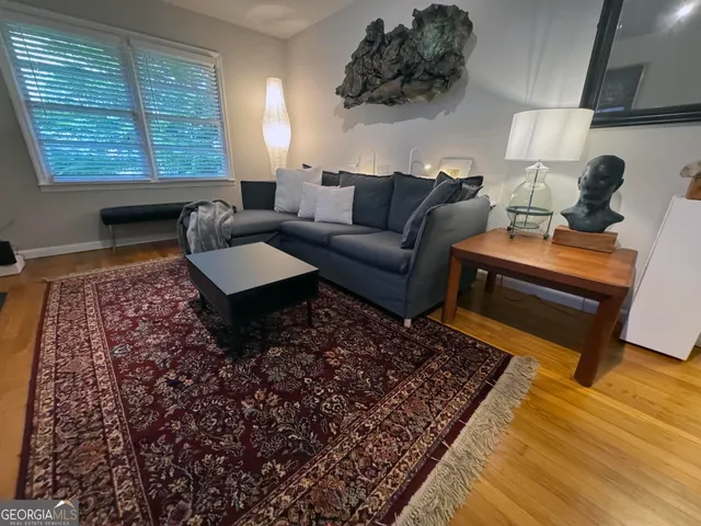a living room with furniture and a rug