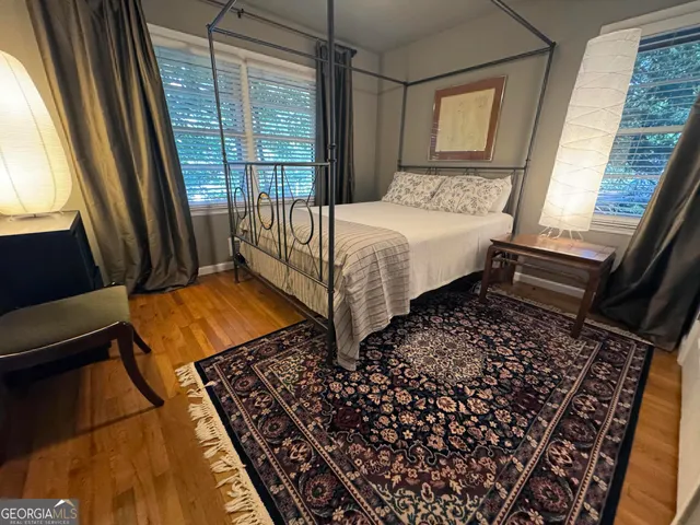 a bed sitting in a bedroom next to a window