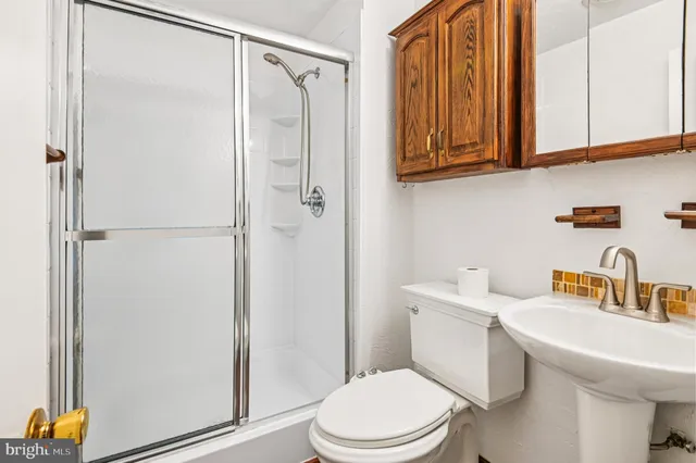 a white toilet sitting next to a bathroom sink