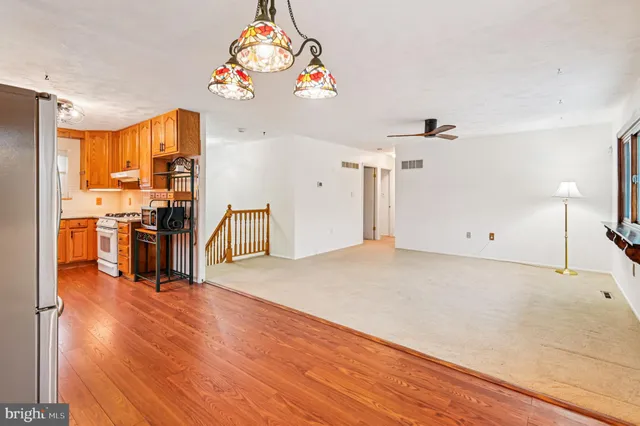 a view of kitchen with furniture and wooden floor