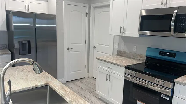a living room with furniture and kitchen view