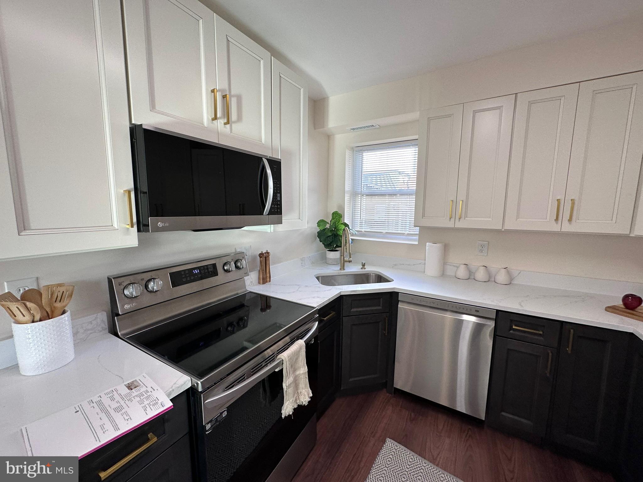 1107 Navahoe Drive Silver Spring, MD 20903 - Photo 11 of 26 a kitchen with a sink stove and microwave