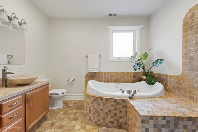 a bath room with a toilet and a sink