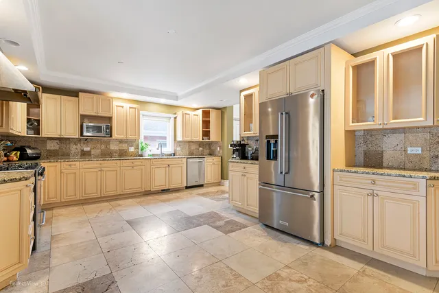 a kitchen with stainless steel appliances granite countertop a refrigerator sink and cabinets